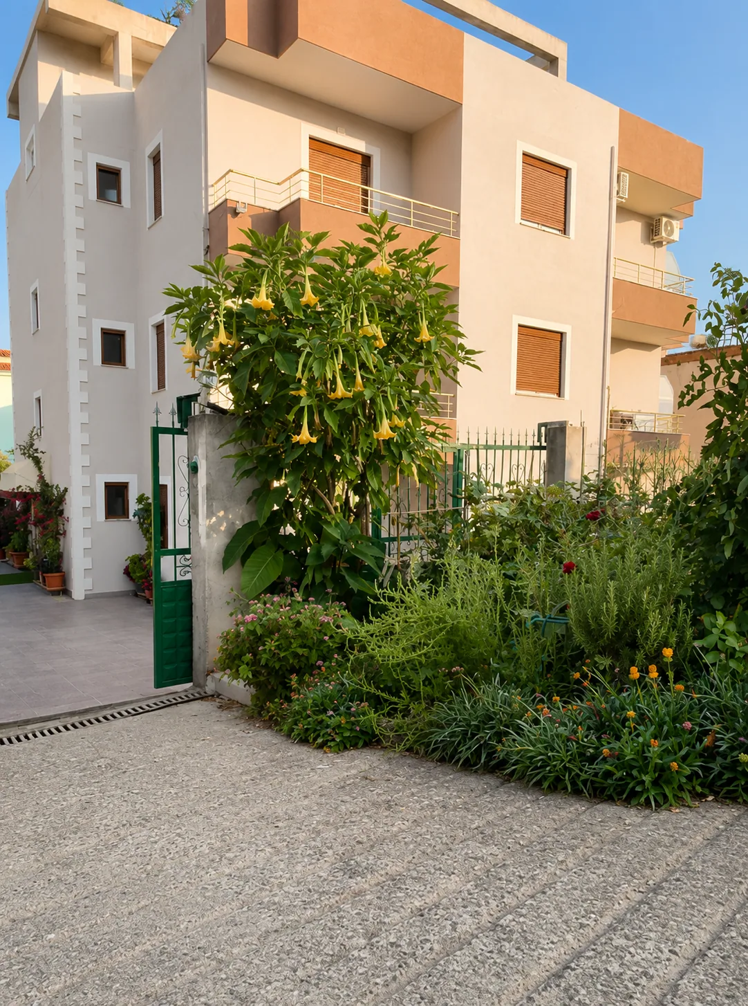 Eldo Apartments building with garden and flowers