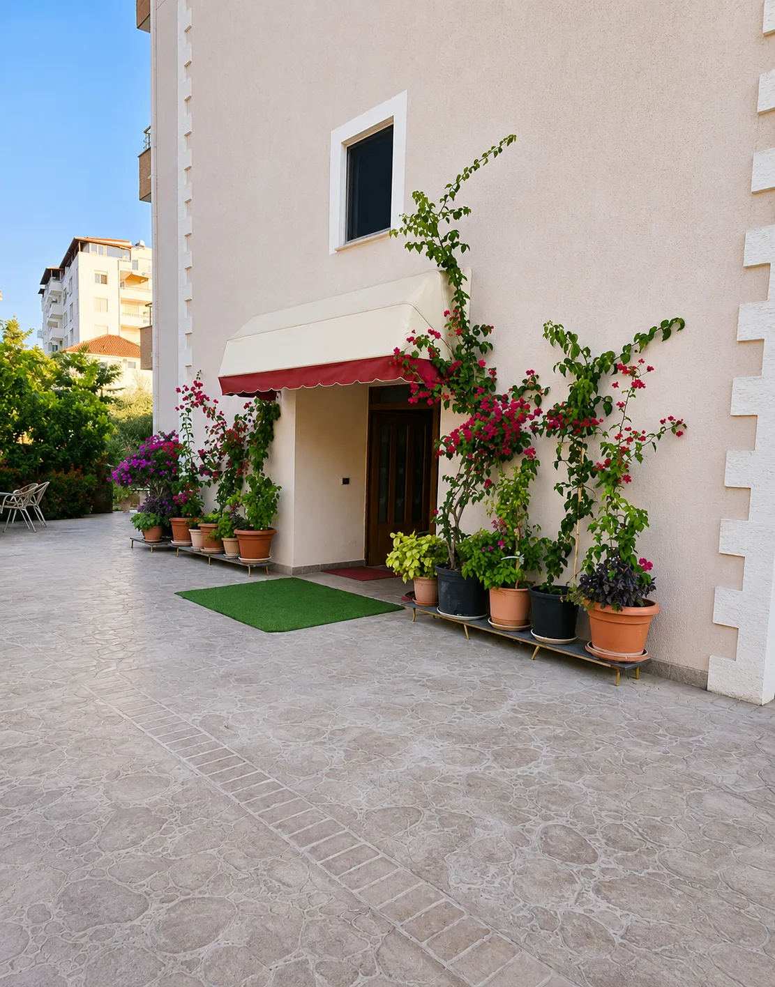 Entrance courtyard with flowers at Eldo Apartments