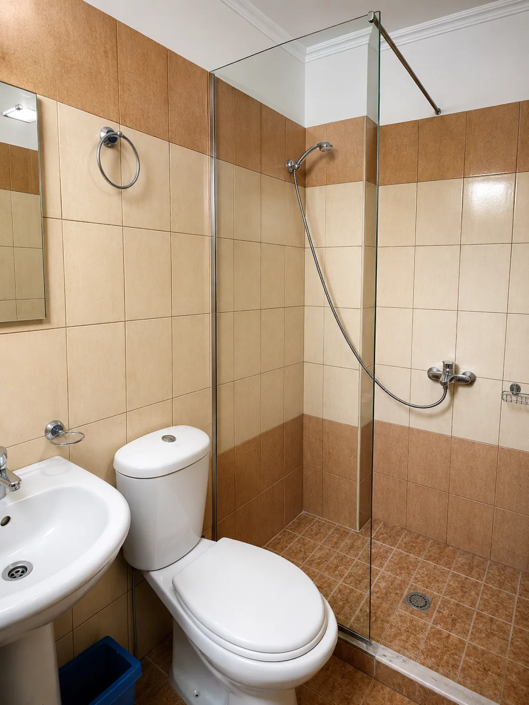 Private bathroom with shower and warm tiles