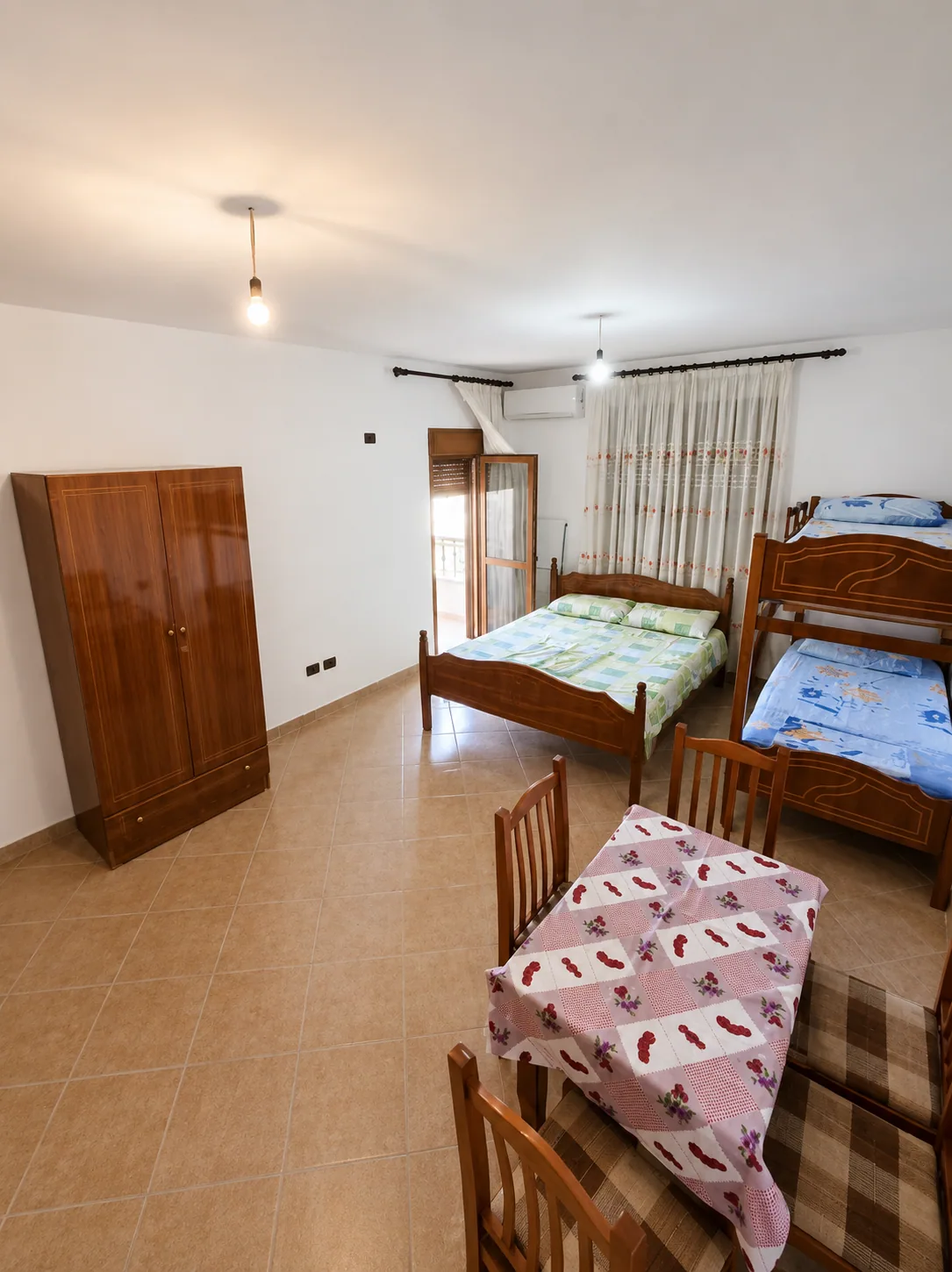 Wide family studio with beds and dining table